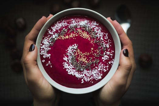 colorful smoothie bowl topped with fruits and seeds