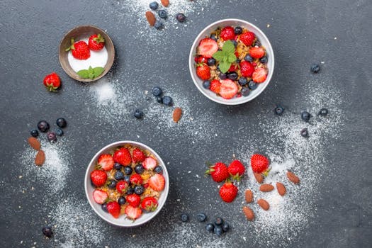 a colorful smoothie bowl topped with fresh fruits and nuts