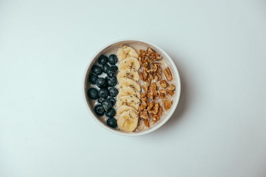 a creamy smoothie bowl topped with fruits and nuts