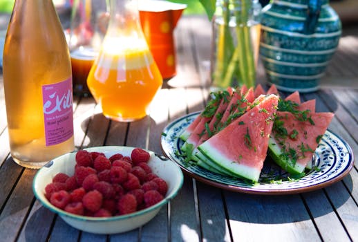 colorful glass of juice surrounded by fresh fruits