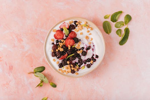 colorful smoothie bowl topped with fruit and nuts