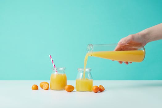 freshly squeezed juice being poured into a glass